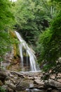 A huge mountain waterfall in the background of stone rocks and g Royalty Free Stock Photo