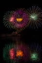 Huge multicolor stars in fireworks over surface of Brno`s Dam with lake reflection Royalty Free Stock Photo