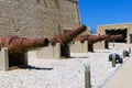 Valletta, Malta, August 2019. The cannon battery of huge old guns at the wall of Fort San Elmo. Royalty Free Stock Photo