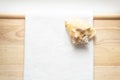 Huge natural seashell on a white towel on a wooden background
