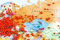 red pins in Europe and other continents on a world map with shallow DoF