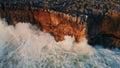 Huge ocean splashes crashing high rocks seacoast in slow motion. Powerful waves Royalty Free Stock Photo