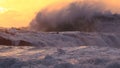 Huge ocean surf crashing over rocks at sunset Royalty Free Stock Photo