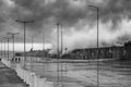 A huge ocean waves breaking on the breakwater at the cloudy stormy day. Breathtaking romantic seascape in the port pier. Bw photo Royalty Free Stock Photo