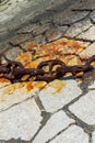 Huge old rusty chain on the stones of the pier Royalty Free Stock Photo