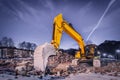 Huge orange shovel digger on demolition site