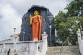 Huge orange statue of Buddha in the yard of temple Royalty Free Stock Photo