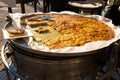 Huge pan with frico, typical dish from Friuli, Italy