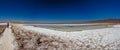 Rear view of tourist walking along Baltinache salar and hidden lagoons