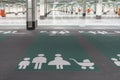 Huge parking space and a sign on the floor of the underground carpark - places for families with children.