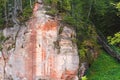 A huge piece of rock with streaks of red and white, bridge leading upwards Royalty Free Stock Photo