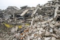 A huge pile of gray concrete debris from piles and stones of the destroyed building. The impact of the destruction Royalty Free Stock Photo