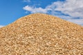 Huge pile of wood chips against the sky Royalty Free Stock Photo