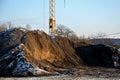 Huge piles of clay and soil are materials moved during the excavation of the foundations of an apartment building. a large constru