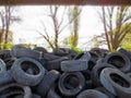 Huge piles from old car tires under a bridge in Varna, Bulgaria. Pollution all around.