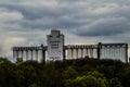 A huge, powerful factory, towering above the green forest..