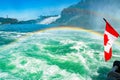 Huge rainbow and Canadian flag, view of Bridal Veil Falls, Niagara Falls, part of Goat Island, Ontario, Canada. High Royalty Free Stock Photo