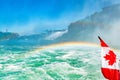 Huge rainbow and Canadian flag, view of Bridal Veil Falls, Niagara Falls, part of Goat Island, Ontario, Canada. High Royalty Free Stock Photo
