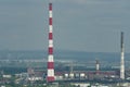 A huge red-white brick chimney in the center of an industrial city. Royalty Free Stock Photo