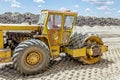 Huge road roller with spikes is compacting soil at construction Royalty Free Stock Photo