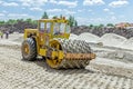 Huge road roller with spikes is compacting soil at construction Royalty Free Stock Photo