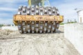 Huge road roller with spikes is compacting soil at construction Royalty Free Stock Photo