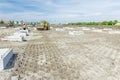 Huge road roller with spikes is compacting soil at construction