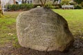 A huge rock with a poem inscribed on it on the back lawn of the Vancouver City Hall by Ina Trudge on March 2000 Royalty Free Stock Photo