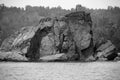 Huge rock in water of Indian ocean in black and white Royalty Free Stock Photo
