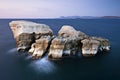 Huge rocks in the sea from Sarakiniko beach in Milos island Greece at sunset time Royalty Free Stock Photo