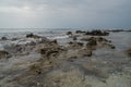 Huge rocks and small stones in the ocean on the beach at the tropical island Royalty Free Stock Photo