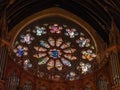 A huge round stained glass window inside St. Colman\'s Cathedral in Cobh, Ireland