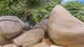 Huge rounded granite boulders on the white sand of the beach.