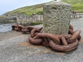 Huge rusted metal mooring chain in a harbour