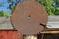 A huge rusty circular saw hanging on a rustic fence Royalty Free Stock Photo