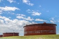 Huge rusty storage tanks full of petroleum products in tank farm in Cushing Oklahoma where most oil in USA is stored and traded