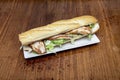 Huge sandwich of chicken on baguette bread