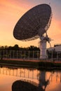 Huge Satellite Dish or Radio Telescope at dusk with reflection Royalty Free Stock Photo