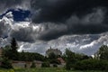 Huge scary ancient creepy castle on the top of the hill under dark cloudy sky Royalty Free Stock Photo