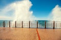 A huge sea wave is breaking on the promenade Royalty Free Stock Photo