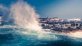 Huge sea waves splashing over the rocks and cape fur seal resting on the rocks at Capetown, South Africa