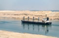 Huge ships navigate by Suez Canal. Desert in Egypt. Concept of transportation and logistics