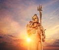 The huge Shiva statue Mangal Mahadev is a 33 m art piece in Ganga talao temple on the blue evening sunset sky, Mauritius island Royalty Free Stock Photo