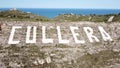 Huge sign on the mountain of Cullera, painted on the slope of the Sierra de los Zorros next to the town