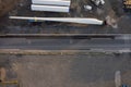 Huge size wind turbine blade on a platform ready for transportation in a yard. Aerial view. Heavy and long cargo movement.