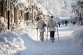 Huge snowdrifts on the city streets after a snowstorm. People have difficulty walking on the street, some use ski poles