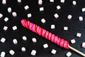 Huge spiral lollipop with marshmallows on black stone background Royalty Free Stock Photo