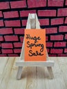 Huge spring sale message on a wood easel Royalty Free Stock Photo
