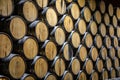 Huge stack of oak barrels aging tequila in a warehouse in Mexico