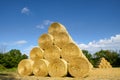 Huge stacked round bales of straw, summer, blue sky Czech Republic.